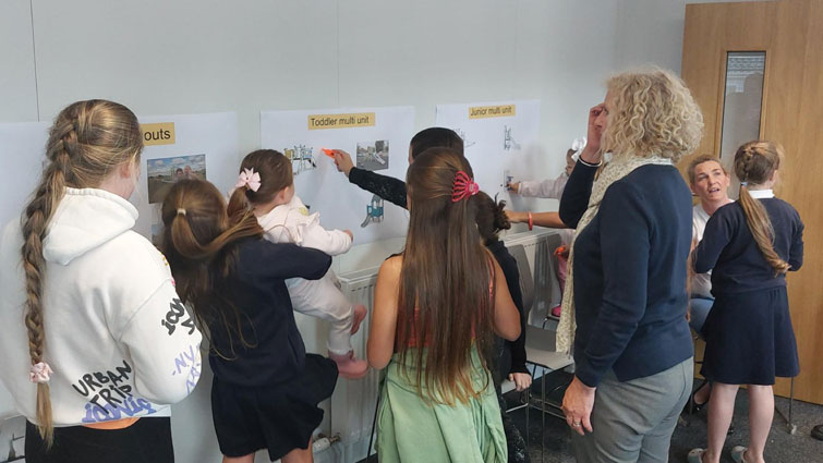 This image shows young gypsy/travellers working on the design of a new play area at their site in Larkhall