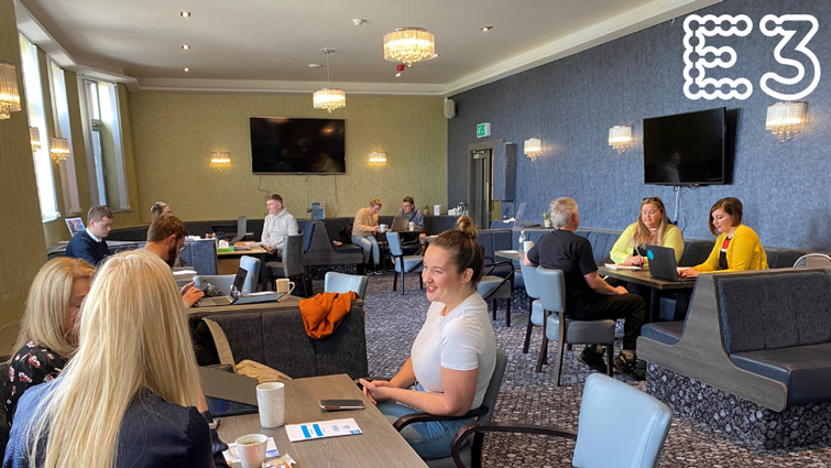 This image shows a group of people enjoying the first co-working event held at E3's Blantyre hub