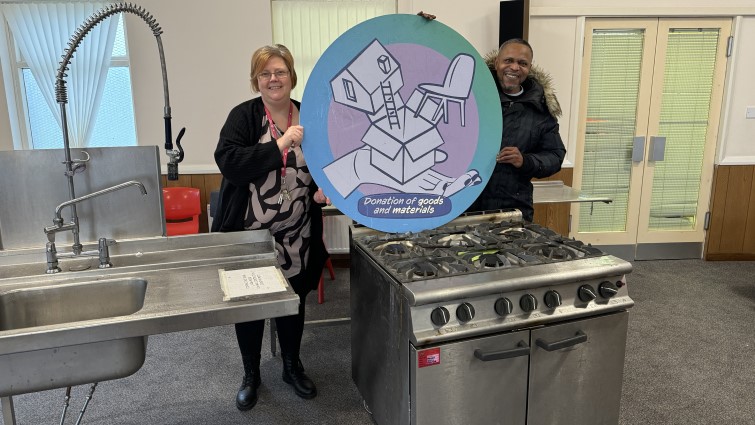 This image shows a representative from Heart of Africa with the cooker they received via the Community Wish List