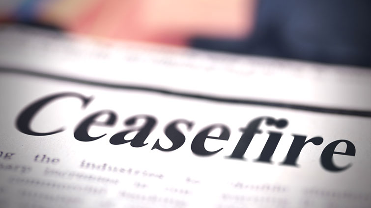 This image has the word ceasefire on a piece of paper that resembles a newspaper