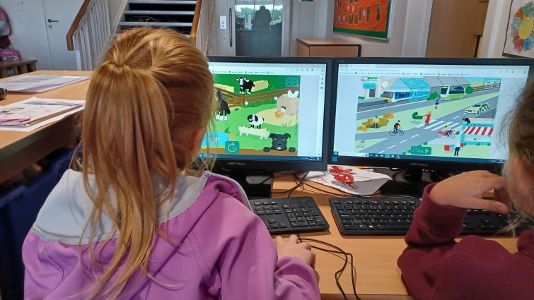 primary school pupils working on computers