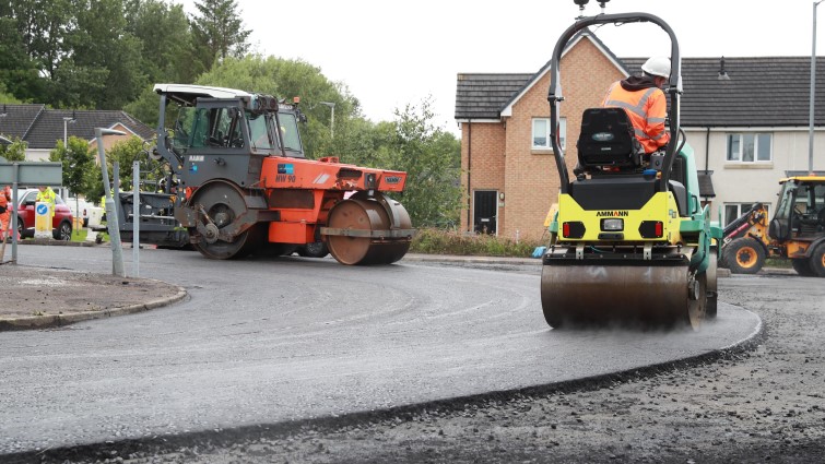 This image shows a roads machine resurfacing a roundabout