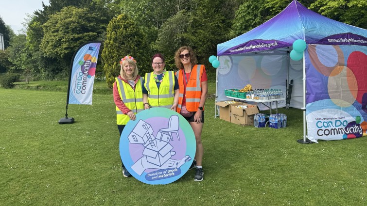 This image shows some of the organisers of the Strathaven junior parkrun with a Community Wish List prop