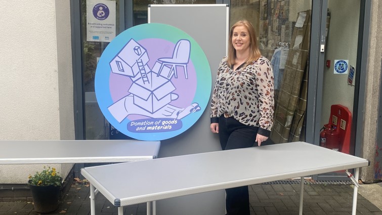 This image shows Joanne Gray of the EK Village Centre with some of the tables they received thanks to the Community Wish List