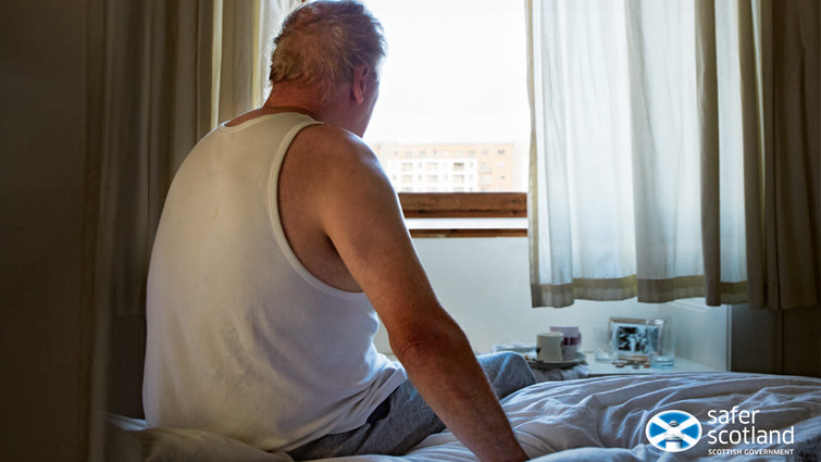 This image shows an adult looking out their window and is related to a survey on adult protection
