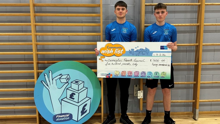 Football players from Calderglen High School's after-school football club display the donation for their new kit. 
