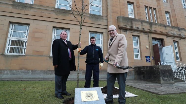 Depute Provost Bert Thomson plants the Coronation Tree outside Council HQ with the help of Deputy Lord Lieutenant William Morrison Young and Grounds Operative Gary O'Raw.