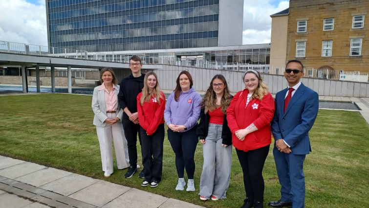This image shows carers outside council HQ with Councillor Kirsty Williams and Soumen Sengupta