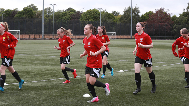This image shows the ICG girls' football team for 2022 in training