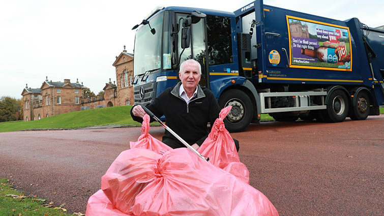 Photo shows Councillor John Anderson in front of a bin lorry at the launch of the council's anti-littering campaign