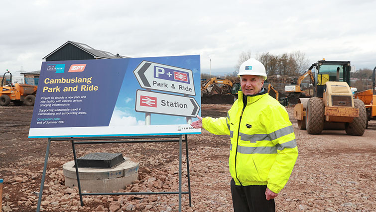 this photo shows Councillor John Anderson at the site of works taking place at Cambuslang Park and Ride