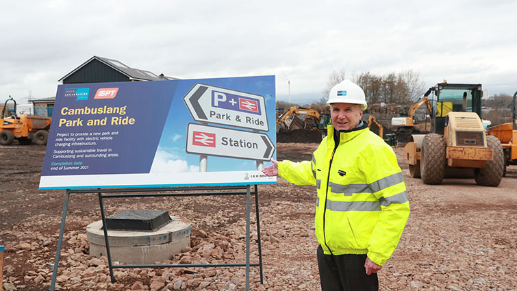 this photo shows Councillor John Anderson at the site of works taking place at Cambuslang Park and Ride 