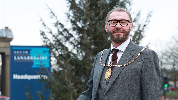 this pic shows Provost Ian McAllan outside council HQ with a Christmas tree in the background