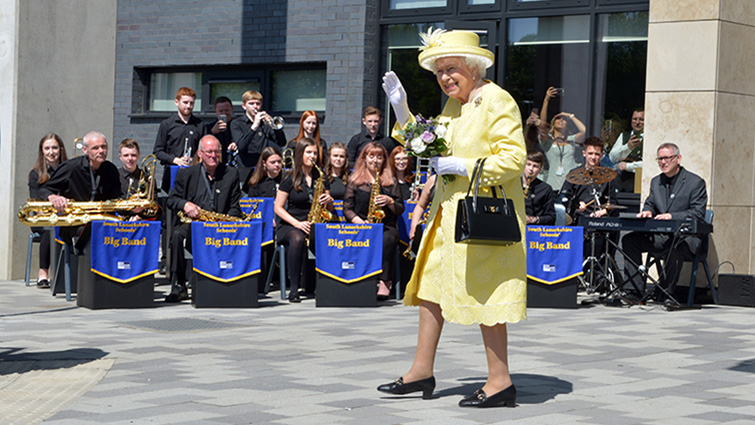 This image shows HM The Queen with South Lanarkshire's big band in the background