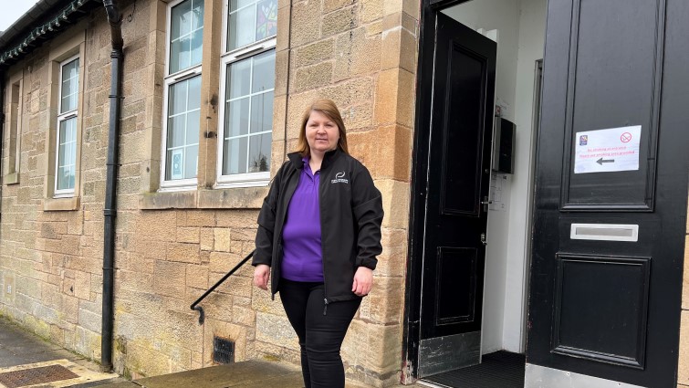 Jacqueline Smith, who found a new job and training through the Connect2Renewables initiative, in front of Douglas Community Hall where she now works. 