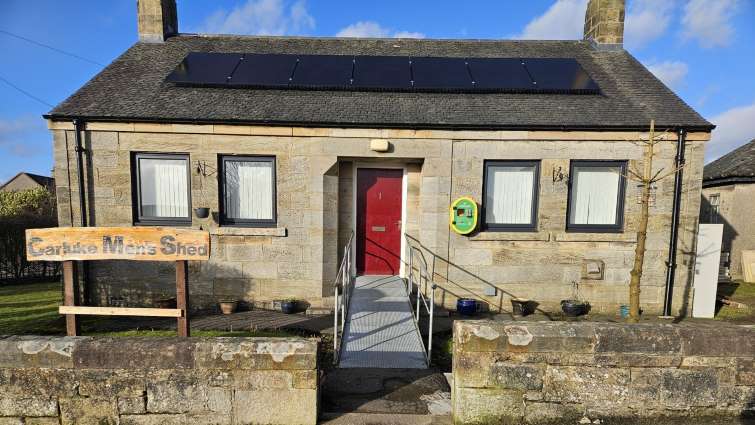 This is an exterior view of Carluke Men's Shed with solar panels on the roof