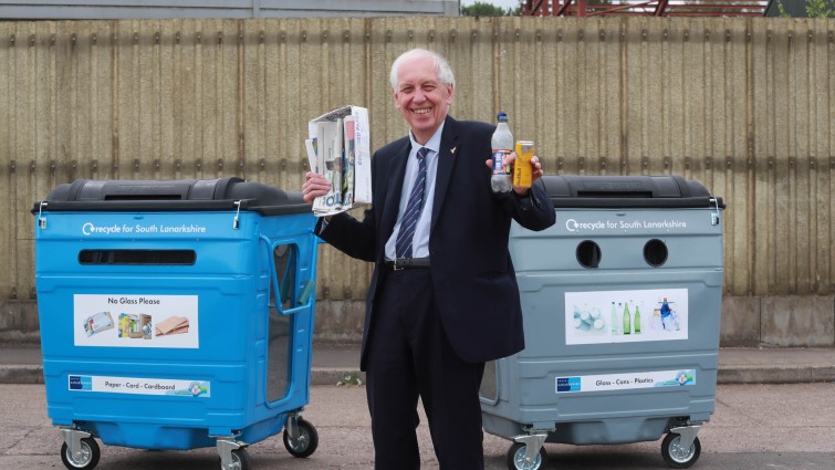 Councillor Robert Brown is pictured with one of each new bin and holding the material which can be accepted by each.