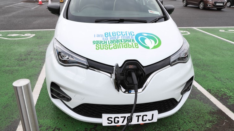 This image shows an electric vehicle being charged