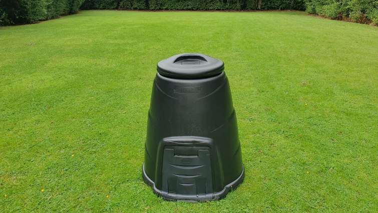 composter bin sitting on grass
