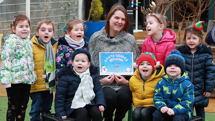 this photo shows nursery teacher Karen MacMillan with children from Crawforddyke nursery and the book she has written to reassure them Santa is still coming this year despite the global pandemic