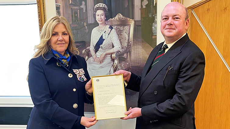 This image shows Lady Haughey CBE, Lord-Lieutenant of Lanarkshire, presenting Colonel Ted Shields MBE with his Deputy Lieutenant’s Commission