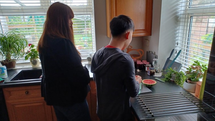 A foster carer in the kitchen with a young asylum-seeker