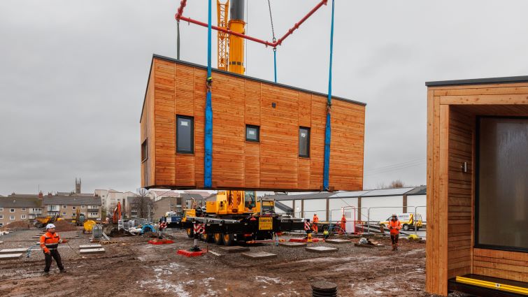 This image shows some of the new housing being lifted into place at Harriet Street, Rutherglen, which will form part of the new homeless accommodation