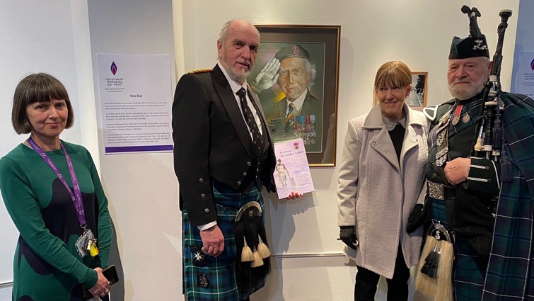 This image shows the artist with other guests and a member of SLLC staff at a painting of Ian Forsyth at the Holocaust Memorial exhibition at Low Parks Museum 