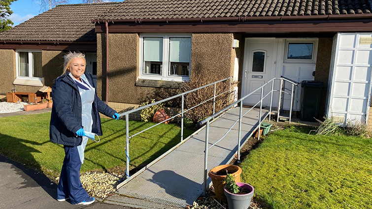 Home Carer Jill Bell outside a service user's house 