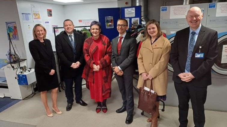 This image shows council leader Joe Fagan and Justice Secretary Angela Constance along with members of SLLC staff on a visit to the Unpaid Work Service 