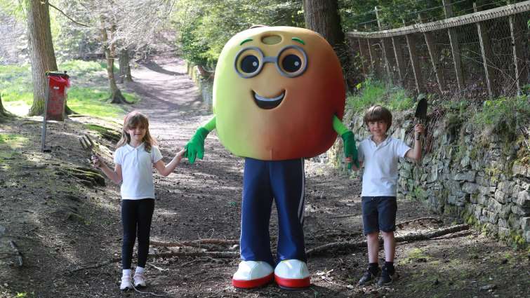 This image shows pupils with Go Fresh character Alan Apple to promote Stop Food Waste Day