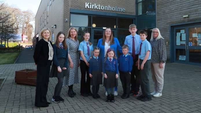 teaching staff and pupils outside Kirktonholme Primary School entrance