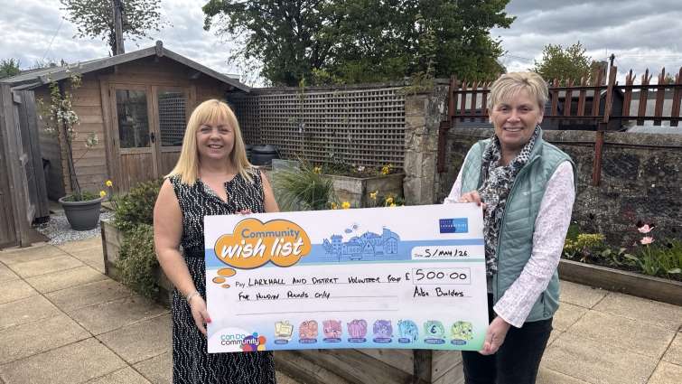 Sandra McCrory from the Larkhall and District Volunteer Group receiving &pound;500 from  Lorraine Redmond from Ailsa Builders following a request to the Community Benefits Hub