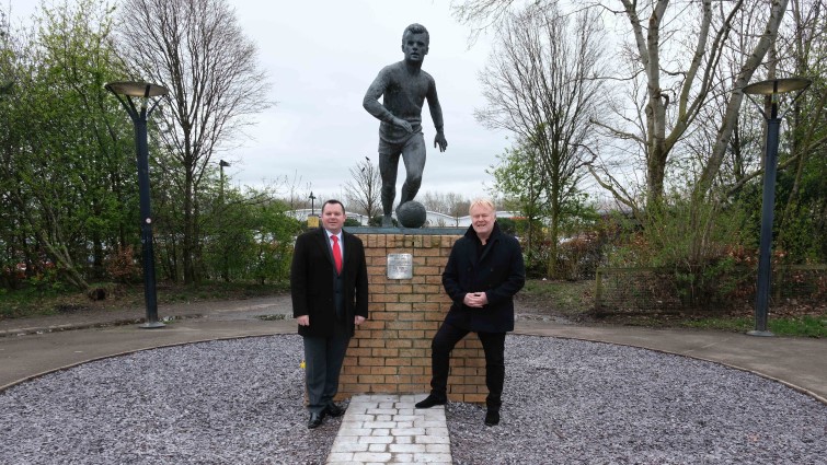 This image shows council leader Joe Fagan and ex-footballer David McKinnon at the Davie Cooper statue at Hamilton Palace Grounds