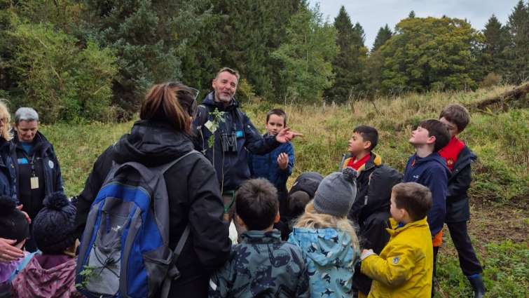 Countryside Ranger showing young people how to plant trees