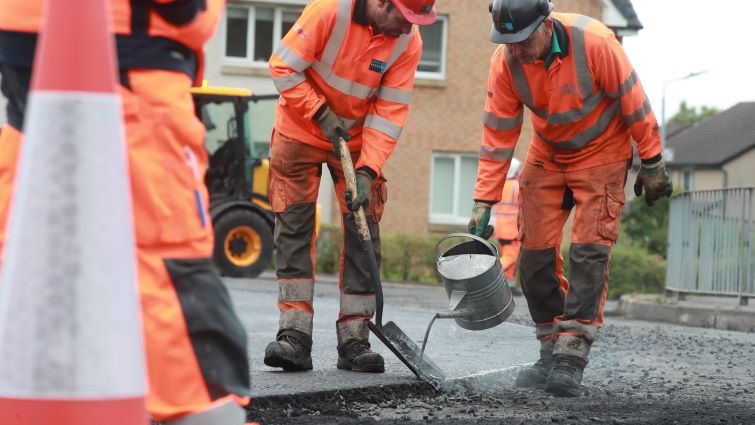 workers pouring tar on road