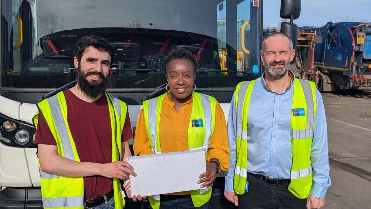 staff standing in front of a bin lorry