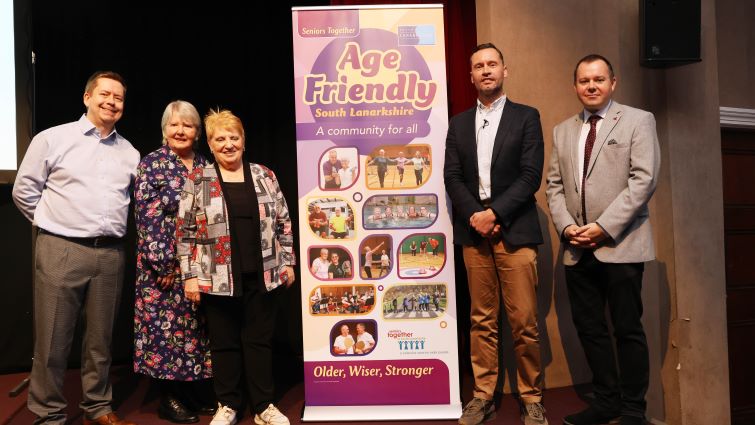 This image shows Council Leader Joe Fagan, Older People's Champion Councillor Eileen Logan, Chief Executive Paul Manning, the chair of Seniors Together and one of the speakers at Seniors Together's recent conference next to a banner 