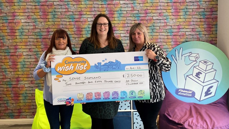This images shows representatives of Sense Scotland and AM Phillip Trucktech following a financial donation to the charity thanks to the council's Community Wish List 