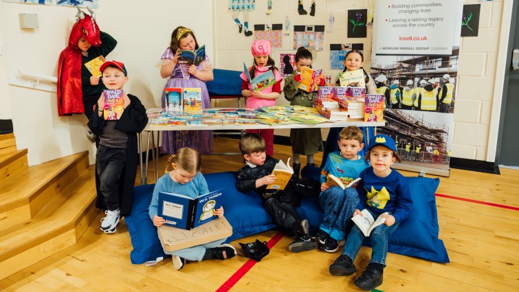 pupils with books donated as part of world book day celebrations