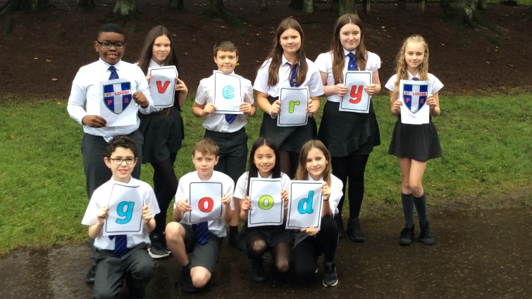 St Louise Primary School pupils holding up a very good message 