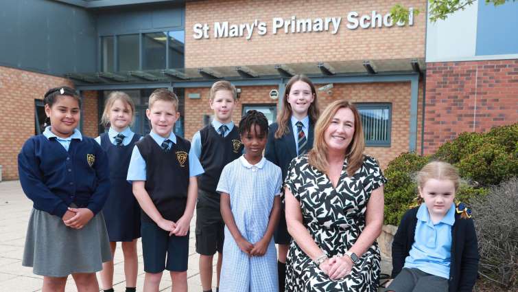 This image shows pupil and staff from ST Mary's Primary School following a very good inspection report by HMI