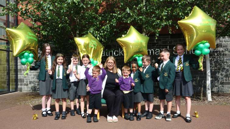 St Patrick&rsquo;s Primary School Acting Head Teacher Laura Layden and pupils holding up balloons 