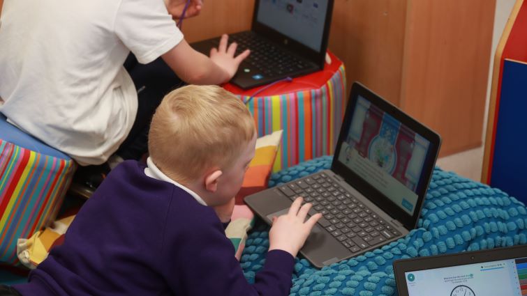 This image shows the back of a pupil working on a computer