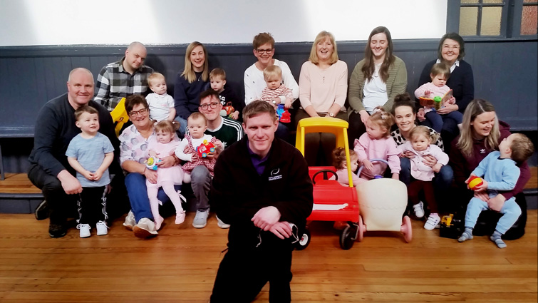Tom Craig Centre Hall Keeper William Craig kneels in the centre of the picture behind him sit the children and adults of Law Toddler Group 