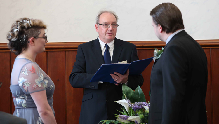 A couple are married by South Lanarkshire Council registrar Alistair Gray