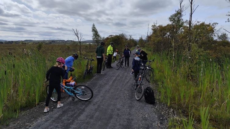 This image shows a variety of people with bikes at a recently opened new active travel path linking Coalburn and Lesmahagow