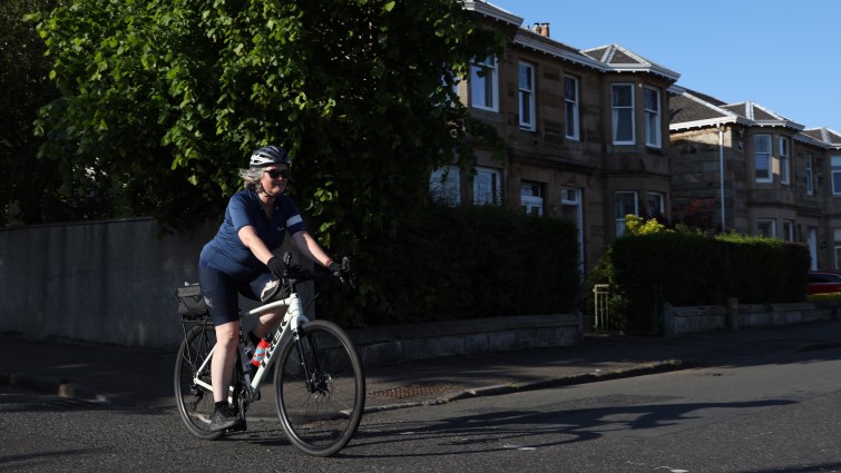 This image shows a cyclist on a road in Rutherglen