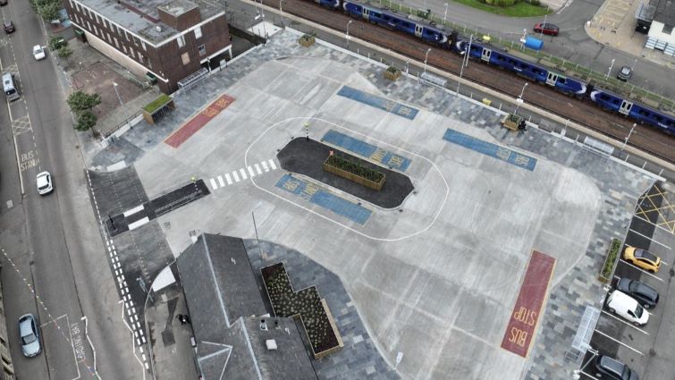 This is a drone shot of the new Lanark interchange, including the bus station, with a train in the background