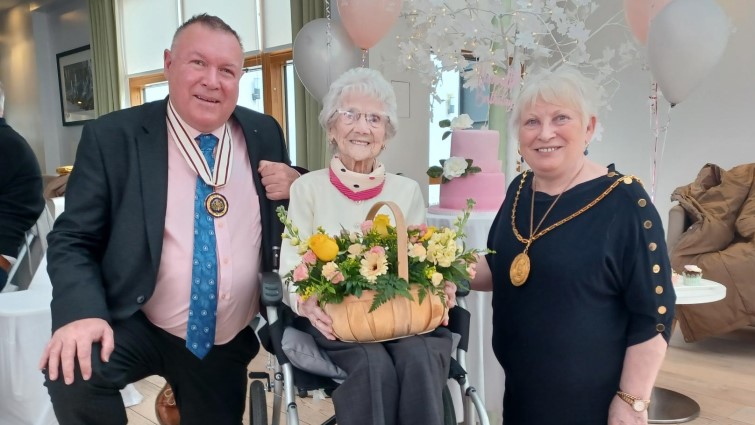 This photo shows Provost Margaret Cooper and DL David Russell celebrating Margaret McDade's 104th birthday